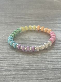 multicolored beaded bracelet on wooden table