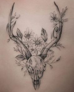 the back of a woman's stomach with an antelope and flowers on it