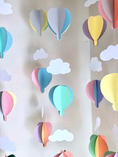 paper hot air balloons are hanging from the ceiling