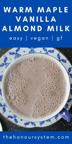 a close up of a cup of coffee on a plate with the words warm maple vanilla almond milk