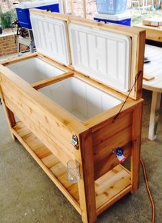 an open wooden cooler sitting on top of a table