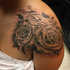 a woman's chest with roses on it and the word love written in cursive writing