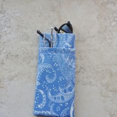 "This double eyeglass case is a great organizer case for 2 pairs of eyeglasses. Made up in a soft blue paisley cotton fabric, there is a blue cotton fabric lining. Case has 2 pockets. The main pocket will accommodate your sunglasses or eyeglasses and the outside pocket is an easy slip in for your readers or a second pair of glasses. Both pockets are fully lined and interfaced for good structure. The outside pocket has a decorative embroidery top stitching. If you prefer, an alternate use for thi Blue Rectangular Case For Everyday Use, Portable Blue Cases For Storage, Blue Rectangular Case For Personal Use, Blue Portable Rectangular Case, Portable Blue Cases For Personal Use, Portable Blue Case For Personal Use, Blue Cases With Pen Holders For Daily Use, Blue Cases With Pen Holders, Decorative Embroidery