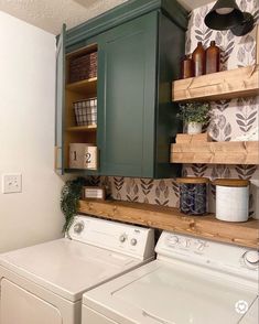 a washer and dryer in a small room with shelves above the washer