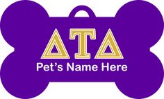 a purple and gold dog bone with the letters ata on it's side