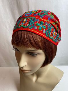 "Charming cotton embroidered cap. It has a timeless old world feel. The colors are bright & bold. I'm not sure of its era, it has no labels or indicators of when it was made. Possibly hand made by someone?  I will say, it has a timeless style.  It has a little covered elastic band in the back which keeps it snug on your head. My feeling it will fit best on a small to average size head.  It is not lined inside. It has a home made quality. No flaws noted.  This is hard to measure honestly, but I w Cotton Beanie Hat With Sweatband, Cotton Beanie With Sweatband, Cotton Beanie With Cotton Sweatband, Hippie Festival Headwrap One Size, Bohemian Fitted Bandana For Festivals, Bohemian Beanie Headwrap, Adjustable Bohemian Headwrap For Festivals, Vintage Red Cotton Hat, Red Vintage Cotton Hat