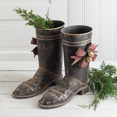 an old pair of boots is decorated with greenery and bows for the holiday season