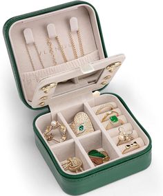 an open green suitcase filled with lots of jewelry