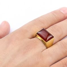 Metal: 14k Yellow Gold Agate: 1.3cm x 1.8cm (0.5" x 0.7") shape - Rectangular cabochon setting type - Bezel setting Product weight: 10.0 gr While you may not be royalty, you'll feel like a king for the day when you sport this ring! This rugged piece features a Rectangular shaped red agate perfectly set in a sparkling 14k yellow gold. A regal masterpiece! ---------------------------------------------------------------------- Agate Agate derives its name from the Greek "Agate" - happy. According t Formal Carnelian Signet Ring With Polished Finish, Modern Red Cabochon Jewelry, Red Rectangular Ring With Polished Finish, Red Rectangular Rings With Polished Finish, Rectangular Red Rings With Polished Finish, Formal Red Carnelian Signet Ring, Anniversary Carnelian Signet Ring With Polished Finish, Modern Carnelian Gemstone Jewelry, Red Carnelian Signet Ring With Polished Finish