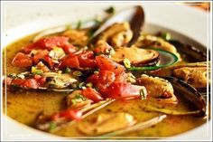 a white bowl filled with food on top of a table