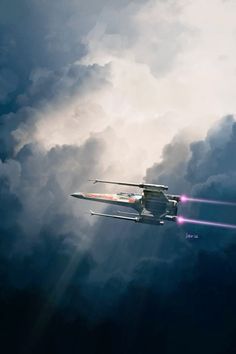 an airplane flying in the sky with clouds behind it and bright beams coming from underneath