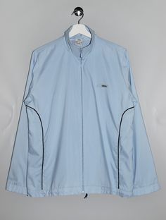 "Vintage 00's Adidas Track Top Light Blue Track Jacket - Size tag: Please always check measurements before buying. Women's L - Measurements (laying flat): Pit to Pit: 22\" Length: 26.5\" Sleeve: 24.5\" Pit to Cuff: 20.5\" Across the shoulders: 16.5\" -Wear: /Please see images for details/ Good vintage condition. -Flaws: / serious wear, tears, holes, marks or stains/ Please see images for details. None - Fabric:  100% Polyester *All of our items are preloved pieces so some signs of natural wear and age are to be expected. Please look through the photos carefully to check if the condition is to your satisfaction. *All efforts are made to show any defects however small imperfections may be missed. *We try to describe the sizes as accurately as possible, but please keep in mind that sizes nowa Luxury Blue Track Jacket For Fall, Sporty Long Sleeve Windbreaker For College, Sporty Long Sleeve College Windbreaker, Blue Sportswear Outerwear For College, Blue Sportswear Outerwear, Blue Stretch Track Jacket, Blue Long Sleeve Windbreaker For Gym, Blue Gym Track Jacket, Blue Long Sleeve Track Jacket For Gym