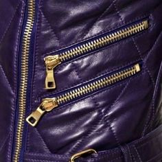 the zippers on this purple leather jacket are very close to the waist and shoulders