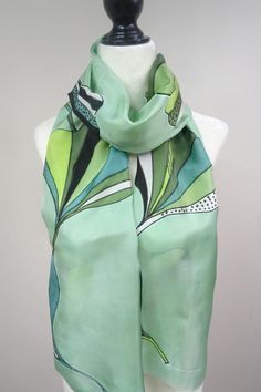 Approximately 14 X 72 inches (35cmX182cm).  Handmade, hand painted 100% habotai silk scarf . Our take on gingko leaves are featured in multiple patterns on a green background. Since this scarf has so many shades of green you can pair it easily with your outfits.  See more scarves from my shop Black Silk Scarf, Green Silk Scarf, Gingko Leaves, Hand Painted Scarves, Habotai Silk, Painted Scarf, Pure Silk Scarf, Silk Scarf Painting, Hand Painted Silk Scarf