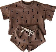 Lightning bolt short set features a brown background and a black lightning bolt. This set... Baby Boy Essentials, Boy Essentials, Mimi Life, Baby Boy Ideas, Baby Luna, French Baby, Diaper Bag Accessories, Footed Pajamas