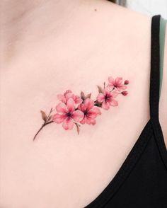 a woman's chest with pink flowers on it