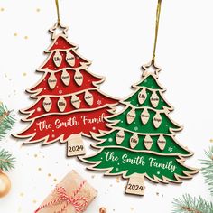 two wooden christmas trees with names on them