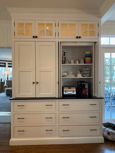 a kitchen with white cabinets and black counter tops