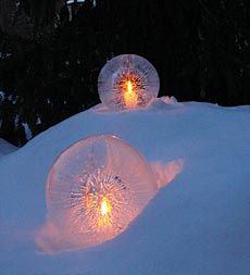 two lights in the middle of snow covered ground with trees in background and text below