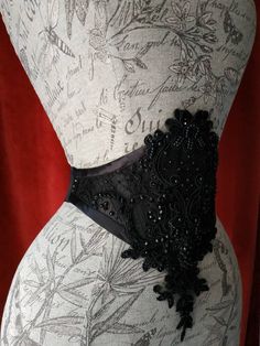 *READY TO SHIP* Gothic waist belt with heavy beaded lace decorated with swarovski . Adjustable with elastic band and metallic regulators. Light boned with syntethic whalebones. Can be worn alone, on dresses, on jackets or on corsets, as you wish! 🌹*SIZE* 🌹 I'll set the elastic band to fit your personal size, please send me your waist measure when you purchase It . Please feel free to ask me, if you have questions. Allow 1-2 business day to pack and go to post office. -------------------------- Elegant Black Corset With Belt, Fitted Party Corset With Belt, Elegant Party Corset With Belt, Lace Corset Belt With Corset Back For Wedding, Elegant Lace Wedding Corset Belt, Elegant Wedding Lace Corset Belt, Elegant Fitted Corset With Belt, Elegant Lace Corset Belt With Corset Back, Black Sash Belt For Party