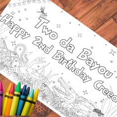 two crayons are next to a happy birthday coloring page