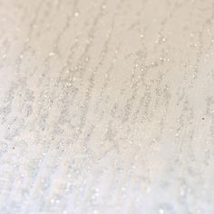 water drops on the surface of a white table top with light blue and black dots