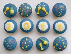 blue cupcakes with yellow and white frosting are arranged in the shape of numbers