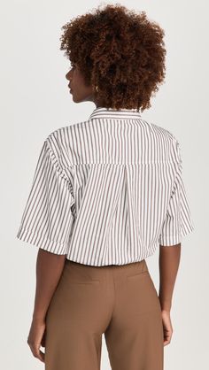 Find STATESIDE 80s Poplin Striped Twist Shirt on Editorialist. Fabric: Lightweight, non-stretch poplin. Stripe pattern. Twisted hem with elastic at back. Collared neck. Short sleeves. Button placket. Shell: 100% cotton. Wash cold. Made in the USA. Measurements: Measurements from size S Length: 19.25in / 49.0cm, from shoulder Poplin Short Sleeve Workwear Blouse, Short Sleeve Poplin Blouse For Work, Chic Poplin Top With Relaxed Fit, Spring Short Sleeve Poplin Blouse, Short Sleeve Poplin Blouse For Spring, Casual Poplin Blouse For Workwear, Relaxed Fit Poplin Top For Work, Striped Tops For Business Casual With Relaxed Fit, Striped Relaxed Fit Top For Business Casual