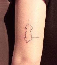 a woman's arm with a small outline of a dog on the left side