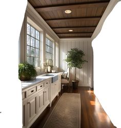 a kitchen with white cabinets and wood floors, along with a rug on the floor