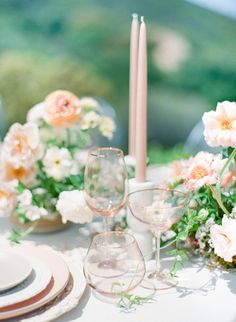 the table is set with pink and white flowers