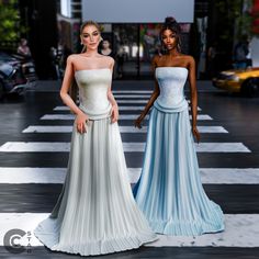 two women in dresses standing next to each other on a cross walk with cars behind them