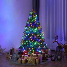 a brightly lit christmas tree with presents under it