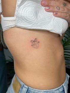 a woman with a small tattoo on her stomach