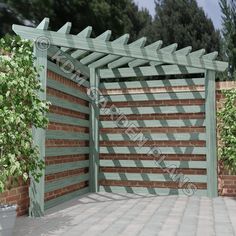 a large wooden gate in the middle of a brick wall with potted plants on either side