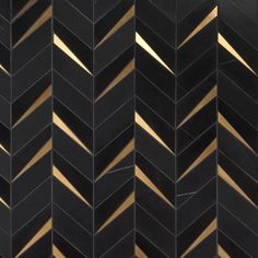 black and gold chevroned tiles with light reflecting on them