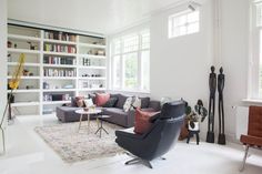 a living room filled with furniture and bookshelves