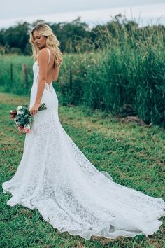 a beautiful blonde woman in a white dress holding a bouquet