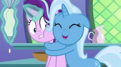 two ponies are hugging in front of a mirror with their faces close to each other