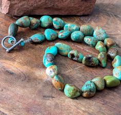 Turquoise Nugget Necklace Kingman Natural Bead Necklace Vintage Turquoise Jewelry Natural Turquoise, Green Brown Turquoise  Natural unstabilized Kingman Turquoise beads. Handcrafted in the Southwest. From 1960s or 70s Turquoise nugget stones are green and brown. The clasp is a toggle clasp. The necklace appears bluer in the photos than it actually is.  Rich and earthy, a great addition to your Southwest Jewelry  Collection.  Can be worn with anything. Measures a bit over 18  inches end to end. Turquoise Necklace With Natural Round Beads, Turquoise Chrysocolla Round Beads Necklace, Turquoise Chrysocolla Necklace With Round Beads, Rustic Turquoise Necklaces With Natural Stones, Bohemian Single Strand Turquoise Necklace, Rustic Turquoise Necklace For Gift, Southwestern Turquoise Necklace With Gemstone Beads, Southwestern Single Strand Turquoise Necklace, Southwestern Style Large Beads Turquoise Necklace