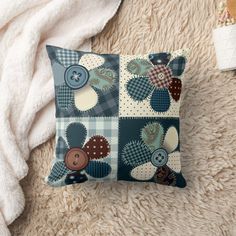 a blue and white pillow with buttons on it