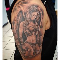 a woman with an angel tattoo on her arm and chest is holding a knife in one hand