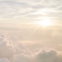 the sky is filled with white clouds and bright sunlight