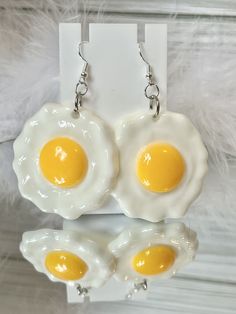 Introducing our adorable Egg earrings, Maximalist Style, Statement Earrings, Handmade Jewelry, Gift, Cloud Novelty, Gift Mode the perfect accessory for anyone who loves to make a statement with their fashion choices. These quirky and fun earrings capture the essence of these charming reptiles in a stylish and unique way. Crafted with attention to detail, they are sure to turn heads and spark conversations wherever you go. Product Details: Material: Plastic, Metal Size:  Approximately 2 inches length and approximately 1 3/4 inches width and 3 inches drop length Shape:  Misc Shipping:  We ship anywhere in the U.S.  See shipping policy for more information Returns:  We do not offer returns or swaps but please contact me if you have a problem with your order. Each of my items are all handmade. Fun White Earrings For Everyday, Fun White Everyday Earrings, Handmade Novelty White Earrings, Handmade Novelty Earrings For Everyday, Novelty White Round Earrings, Egg Earrings, Funny Jewelry, Weird Jewelry, Maximalist Style