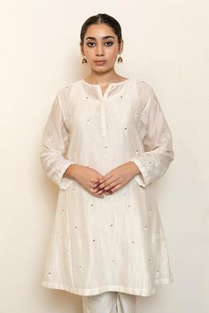 Ivory kurta with embroidered floral butti motifs and sequin embellishments. Comes with an inner and matching pant.
Components: 3
Pattern: Embroidered
Type Of Work: Thread, Sequin
Neckline: Round
Sleeve Type: Three quarter
Fabric: Chanderi Silk, Lining: Cotton
Color: Ivory
Other Details: 
Straight silhouette
Note: Dupatta worn by the model is not for sale
Occasion: Sangeet,Mehendi and Haldi - Aza Fashions Transitional Off-white Sets With Floral Embroidery, White Salwar Kameez With Floral Embroidery For Transitional Seasons, Transitional White Salwar Kameez With Floral Embroidery, White Floral Embroidered Salwar Kameez For Navratri, Elegant White Cotton Silk Sharara, White Cotton Silk Sharara With Resham Embroidery, White Cotton Silk Sharara For Eid, Elegant White Kurta With Floral Embroidery, Unstitched White Slub Silk Salwar Kameez