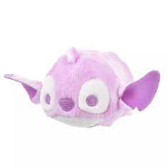 a purple and white stuffed animal with big ears on it's head is flying through the air