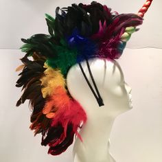 Pride- Unicorn cosplay- feather Head Piece- Rainbow- Burning Man- Music Festival Hello, This piece has a 10 inch fabric unicorn in the front. Down the center are coque feathers that are 6 to 7 inch off the head. The edge close to the head are marabou feathers. It's all attached to a 1/4 inch stainless steel headband wrapped satin material. The headband is a double so it stays on your head while you dance! I can in any color to match your hair. This headband is very comfortable. ----------------- Multicolor Novelty Costume Accessories For Carnival, Multicolor Rave Costume Accessories For Costume Party, Multicolor Rave Costume Accessories, Feather Costume Accessories For Carnival Cosplay, Feathered Costume Hats And Headpieces For Mardi Gras, Feathered Hats And Headpieces For Mardi Gras Costume Party, Multicolor Costume Accessories For Carnival, Mardi Gras Costume Hat With Feathers, Multicolor Costume Hats And Headpieces For Carnival