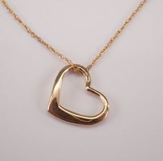 Small Heart Pendant and Chain crafted in 14 Karat yellow gold. The heart measures 10 X 12 mm and weighs .8 grams with the 18" included chain. The pendant and the chain are both 14K Yellow Gold and will be delivered promptly in a gift box. ADDITIONAL REQUESTS If you would like to see more pictures of this item, please let us know and we would be happy to provide them for you. Please contact us with all questions, we are here to help. Yellow Gold Open Heart Necklace Stamped 14k, 14k Yellow Gold Open Heart Necklace, Formal Open Heart Jewelry For Valentine's Day, Formal Yellow Gold Heart Necklace For Valentine's Day, Formal Hallmarked Heart Necklace For Valentine's Day, Yellow Gold Open Heart Necklace With Polished Finish, Formal Yellow Gold Heart Necklace, Hallmarked Yellow Gold Open Heart Jewelry, Yellow Gold Open Heart Hallmarked Jewelry