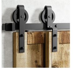 two black metal hooks on the side of a wooden door