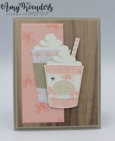 a card with a cup of coffee and a straw in it on top of a wooden background